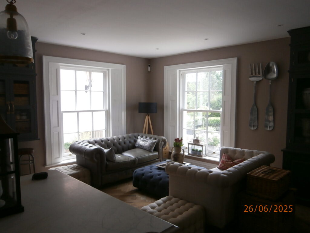 An internal picture of the bespoke sliding sash windows and timber shutters.